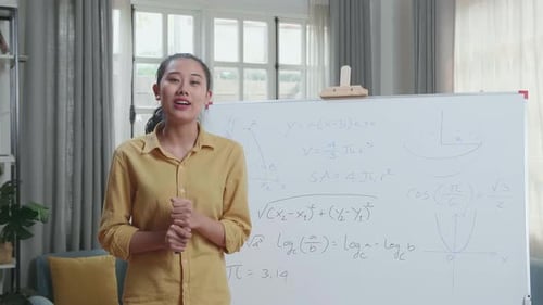 Woman Explains Math Equations in an Indoor Setting