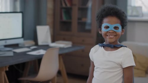 Smiling Child in Superhero Costume Indoors