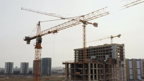 Bau von Luftaufnahmen mit Hochturmkranen, die auf der Baustelle in der Großstadt arbeiten