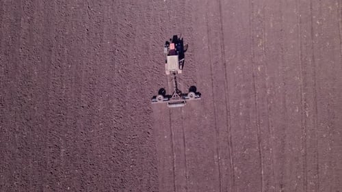 Tractor Tilling Center of Farm Field in the Fall