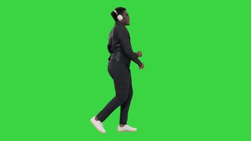 Guy Listening To Music and Dancing While Walking on a Green Screen, Chroma Key.