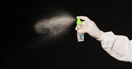 Spraying Disinfectant from Bottle for Healthcare Use