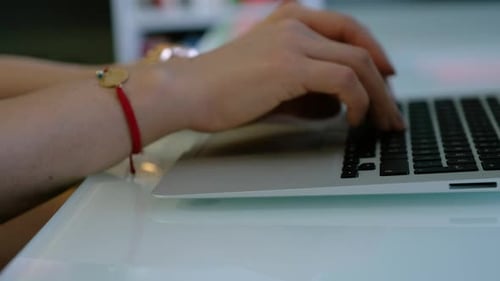 Pretty woman sitting at the desk in the office