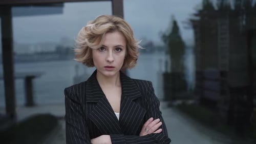 Portrait of Serious Lady Crossing Hands at Camera Outdoors