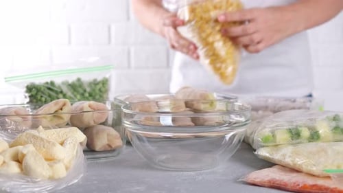 Woman Pours Corn into Glass Bowl for Cooking