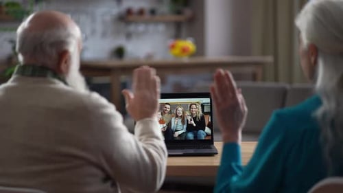 Senior Couple Video Calling with Family on Laptop