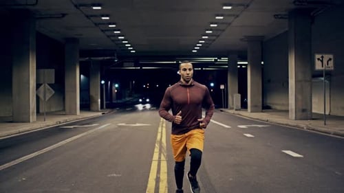 Athletic Male Running Through A Tunnel