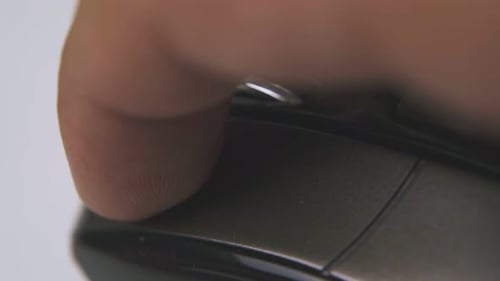 Man Clicks Button on Computer Mouse in White Background