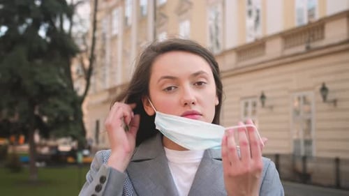 Young Woman Putting On a Face Mask