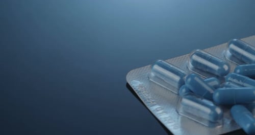 Light Blue Pills in Blister Pack on Blue