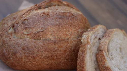 Freshly Baked Bread with Slices on Paper