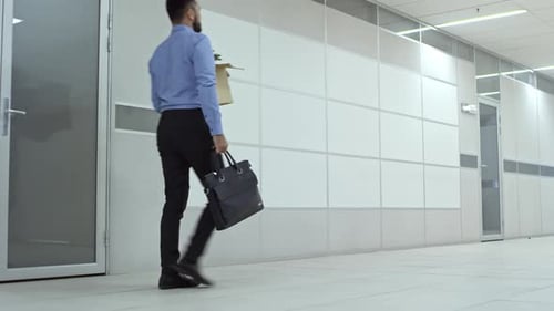 Businessman Carrying Belongings in New Office Building