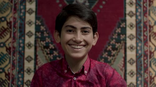 Teen Smiling Portrait in Front of Rug