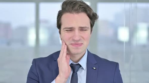 Portrait of Sick Young Businessman Having Toothache