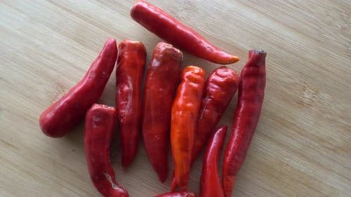 Fresh Red Chili Peppers on Wood Background
