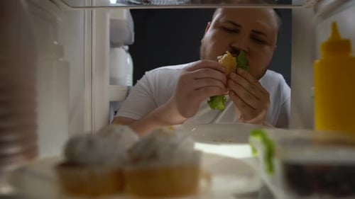 Addicted Obese Man Eagerly Eating Burger at Night, Unhealthy Nutrition, Diet