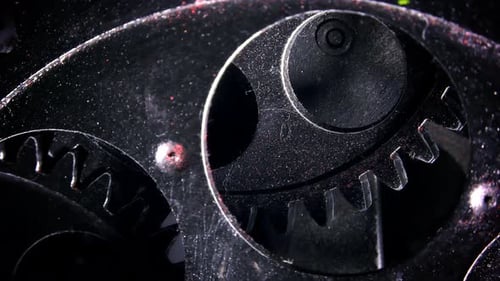 Shiny Metal Gears Rotate in Dark Close Up