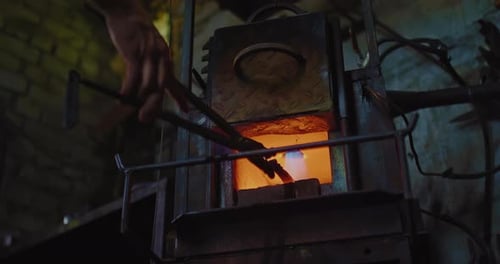Furnace in Forge Blacksmith is Taking Out Red Hot Knife By Special Tongs Closeup View Prores