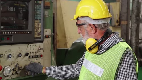 Senior Factory Worker Teach How to Use Machine Equipment in the Factory Workshop
