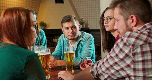 Group of Friends Talk at Bar with Beer
