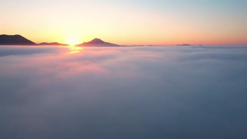 4K Aerial video Beautiful sunrise above dense clouds and fog in the morning