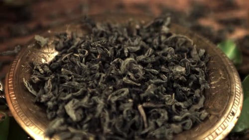 Green Tea Leaves Filling Bowl Close Up