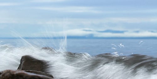 Gentle Waves Lapping Against Rocks at Water's Edge