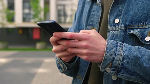 Hands Using Smartphone in Urban Setting