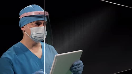 Doctor Uses Tablet in Protective Gear
