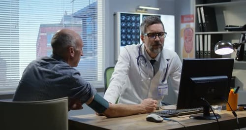 Male Doctor Checking Blood Pressure