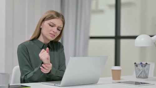 Woman Experiences Wrist Pain While Using Laptop