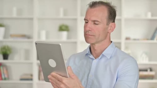 Man Using Tablet Computer in Home Office