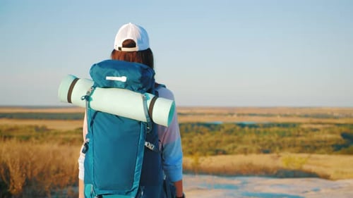 Hiker with Backpack Enjoying Expansive Natural Vista