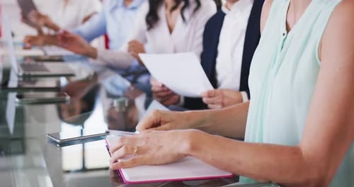 Professional businesspeople clapping together in meeting room in modern office in slow motion