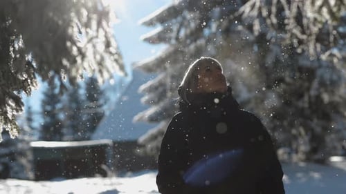 Young Woman Enjoying a Winter Day in Nature in Forest, Snowing on a Sunny Day, Slow Motion, Portrait
