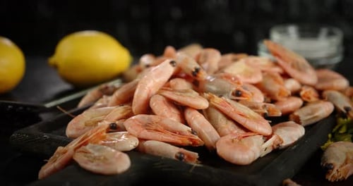 Cutting Board in Boiled Shrimp Rotates on the Table.
