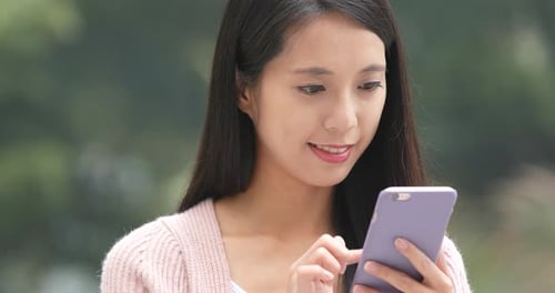 Young Woman Using Smartphone Outdoors