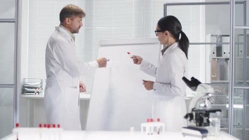 Biochemists Doing Research in Laboratory