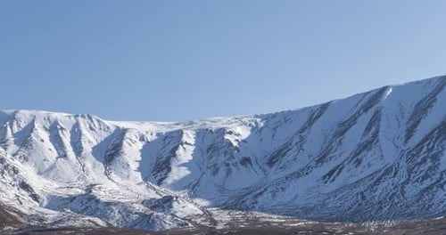Timelapse of Sun Movement on Crystal Clear Sky Over Snow Mountain Top
