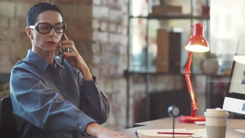 Mid-Aged Businesswoman Having Phone Talk in Office