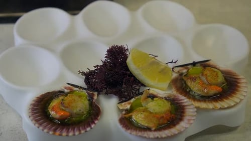 Cooked Scallops Garnished and Placed on Serving Dish