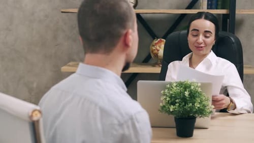 Young Man Is Interviewing for Job at Female Manager in Office