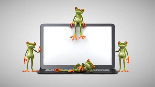 Des grenouilles vertes amusantes à côté d'un ordinateur portable