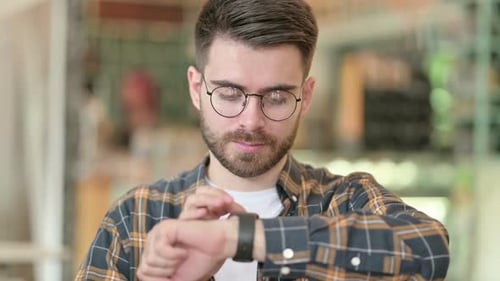 Young Adult Using Smartwatch Technology in Urban Setting