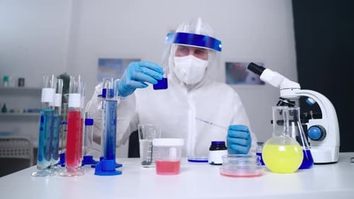 Scientist Using Pipette to Transfer Liquid in Lab