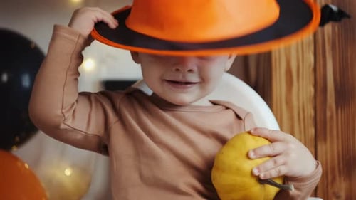 Cute Baby Wearing a Halloween Hat and Smiling