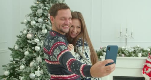 Loving Couple Taking Christmas Selfie at Home