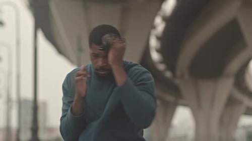 Man Shadow Boxing in Urban Area Outdoors