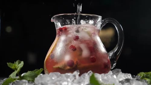Refreshing Bubbly Drink Being Poured into Glass Pitcher