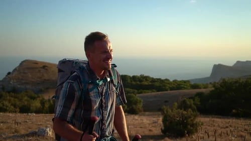 Portrait of Young Man Climbing Mountain in Countryside on Summer Day Spbd